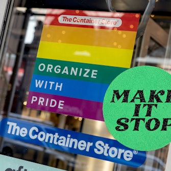 "Organize with Pride" sign in pride colors as an ad on the door of a container store, mocking corpor...