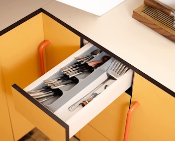 A compact cutlery organizer makes the most of drawer space.