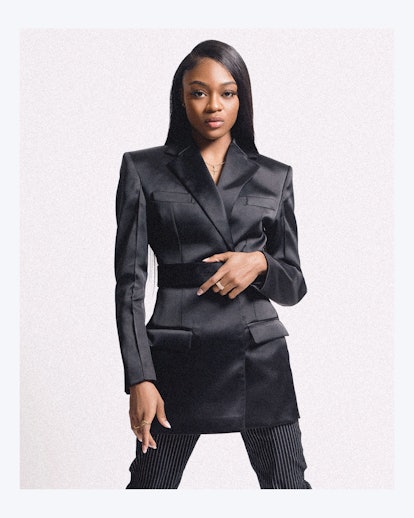 Imani in a black silky suit