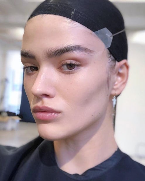 A model shows off her face tape