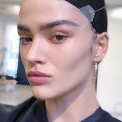 A model shows off her face tape