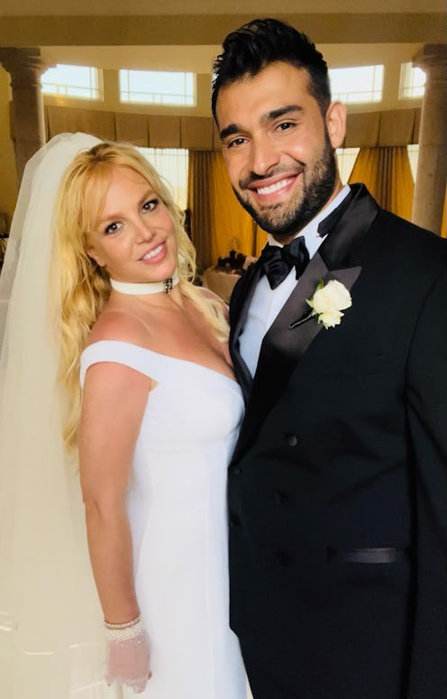 Britney Spears in a custom versace dress during her wedding to Sam Asghari who's wearing a black tux