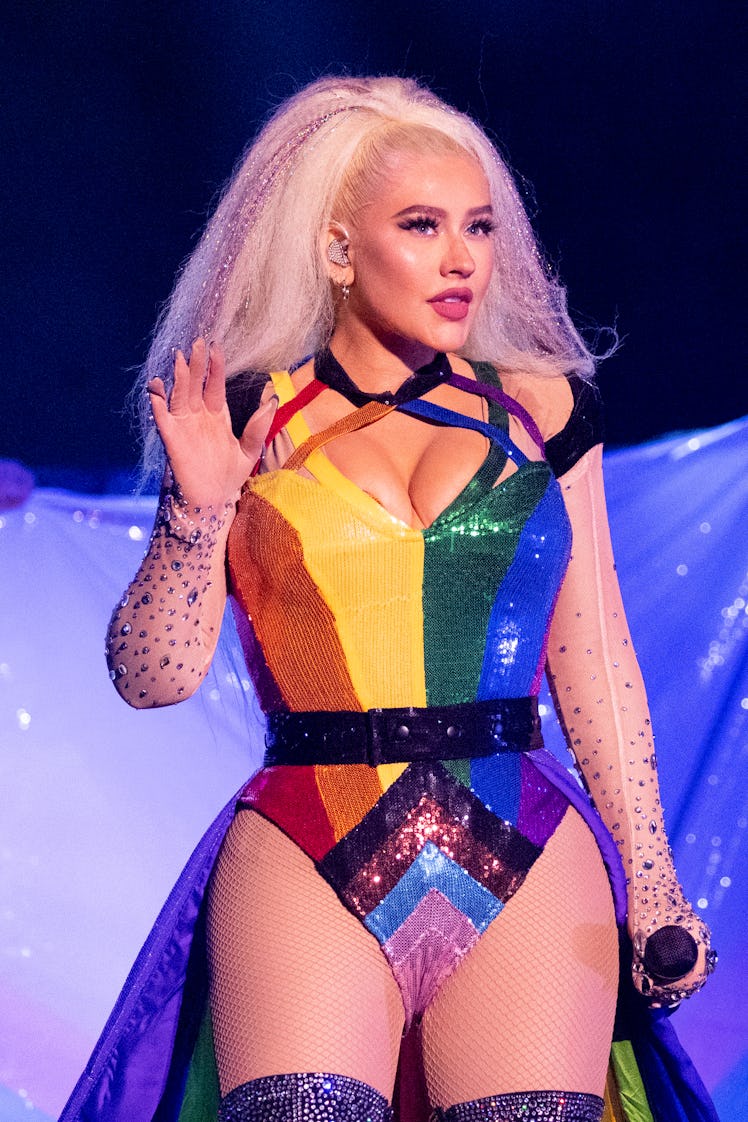 xtina in rainbow body suit and pride flag 