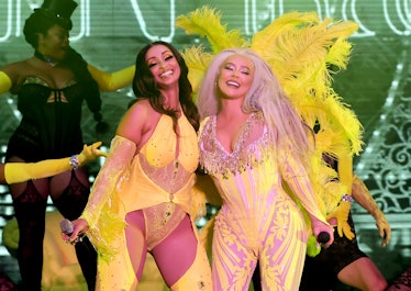 mya and xtina wearing yellow with xtina in yellow feathered look