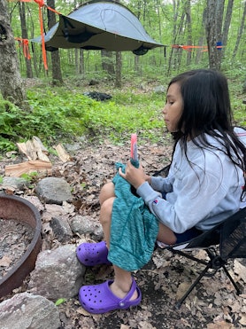 A little girl sitting eating a popsicle at a campsite with the Tentstile Stingray 3-Person tent