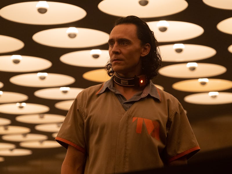 Loki in season 2 with a tracker on his neck and a grey button-up