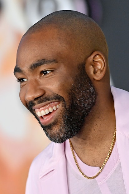 Donald Glover with his shaved head smiling