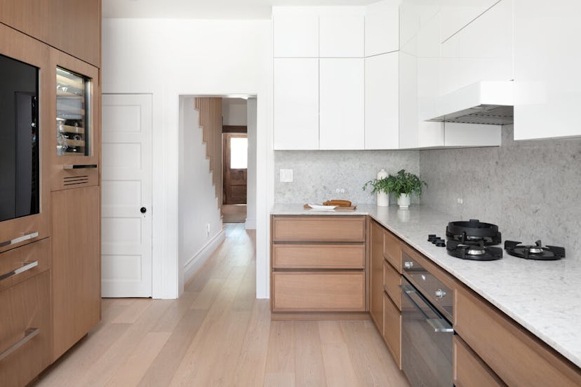 Try white cabinets on top to open up your galley kitchen