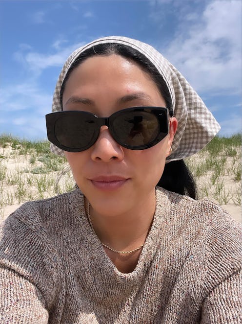 Kathy Lee wearing sunglasses and a head scarf for sun protection