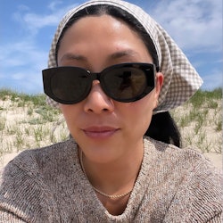 Kathy Lee wearing sunglasses and a head scarf for sun protection