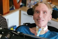 Dr Peter Scott-Morgan pictured in his wheelchair looking at the camera