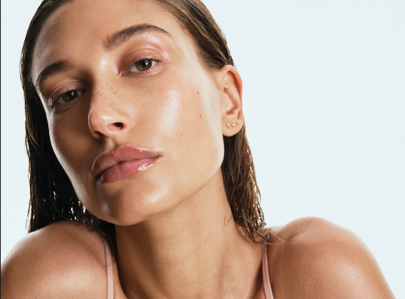 Hailey Bieber looking dewy in Rhode skincare ad.