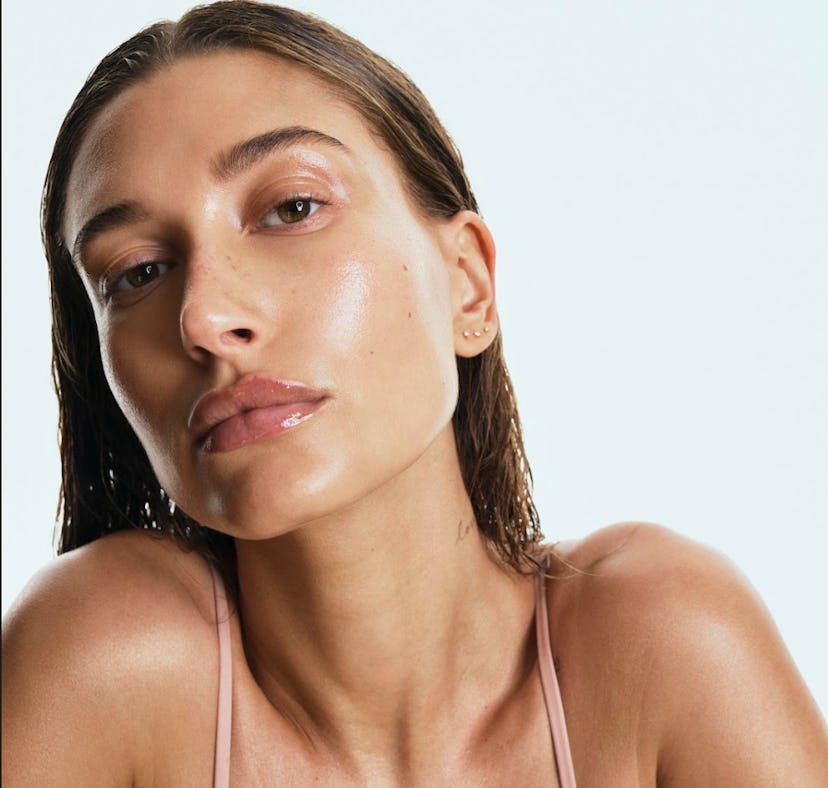 Hailey Bieber looking dewy in Rhode skincare ad.