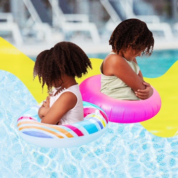 Two girls in a wave pool, with water vests ballooning around their bodies, both standing with their ...