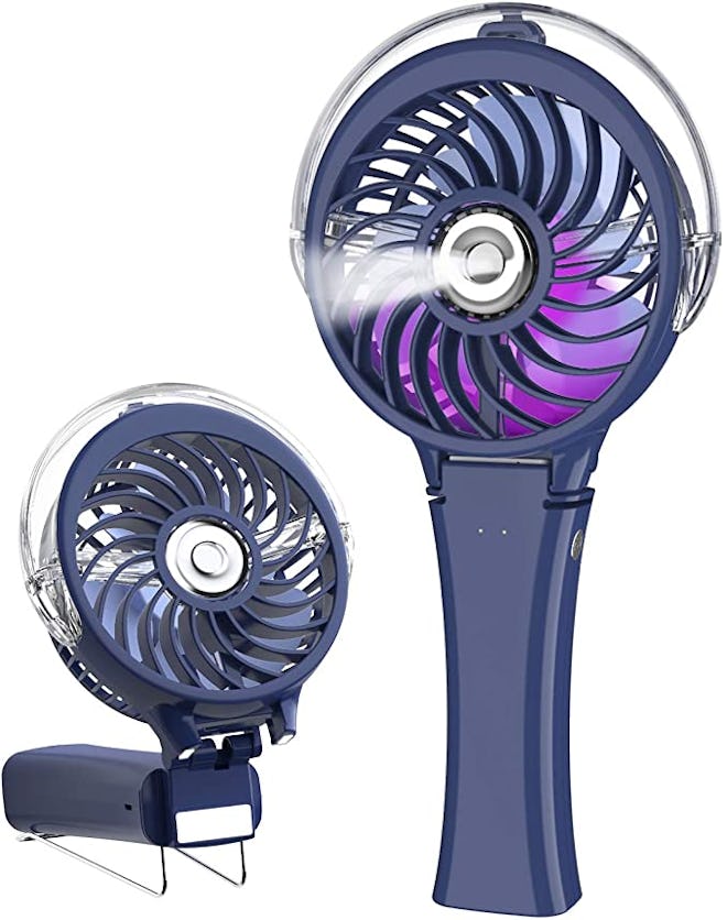 purple and navy blue HandFan Handheld Misting Fan with water mist coming out of it