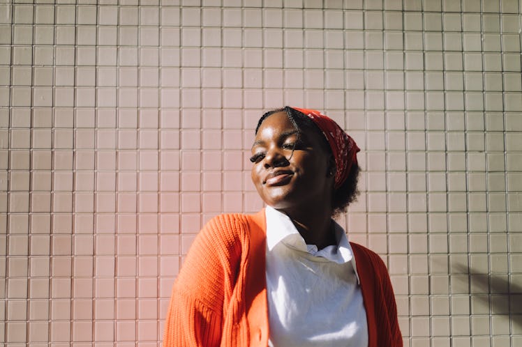 Young woman closing her eyes in the sun during the 2022 summer solstice.