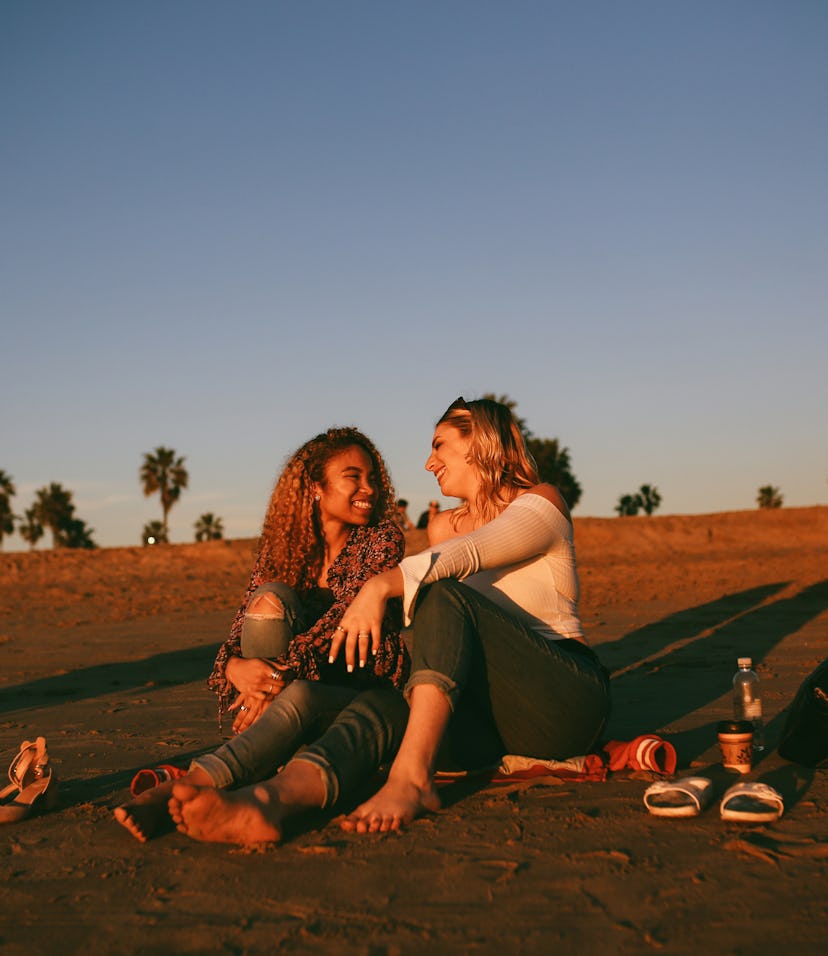Young couple on the beach in summer 2022, the most romantic season for their zodiac signs.