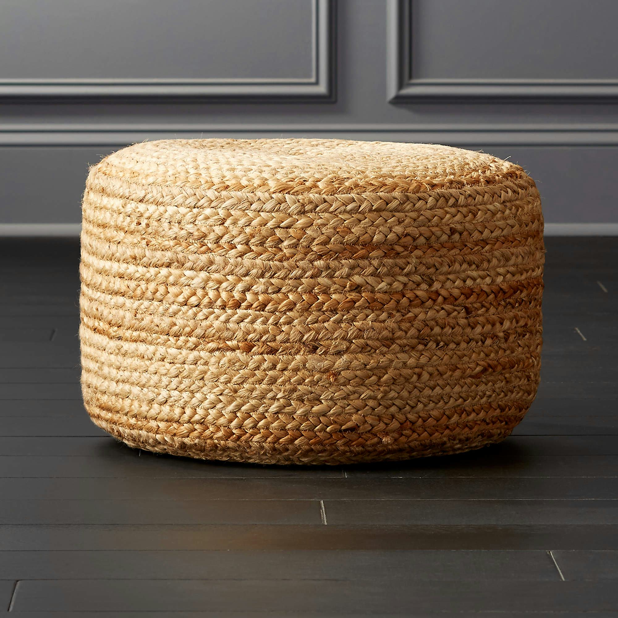CB2 braided jute poof on hardwood floor
