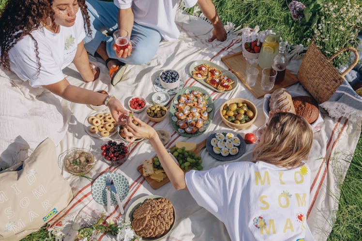 IKEA's BLOMMA from the Midsommar collection is worn and displayed by friends at a summer picnic.