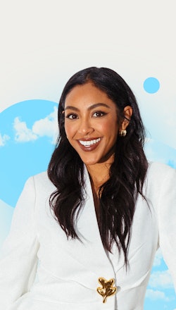Tayshia Adams smiling for an exclusive interview in a white blazer with Elite Daily's Chill Sesh 