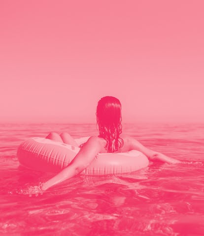 Young woman in a sprinkled doughnut float at the beach during the 2022 summer solstice, which will a...