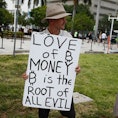 MIAMI, FLORIDA - APRIL 8: Abram Horner holds a sign outside the Miami Beach Convention Center during...