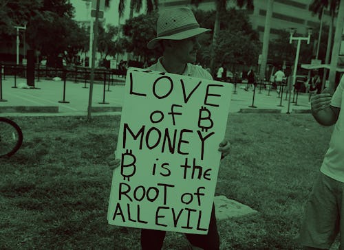 MIAMI, FLORIDA - APRIL 8: Abram Horner holds a sign outside the Miami Beach Convention Center during...