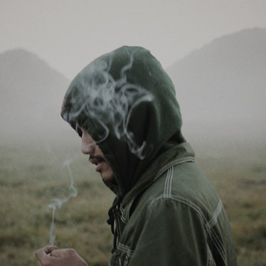 A man inhaling smoke - air pollution