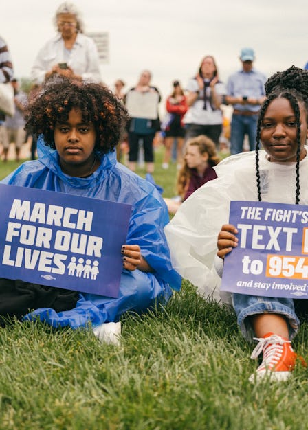 Two young protestors at the March for Our Lives rally in Washington, D.C. holding signs made by the ...