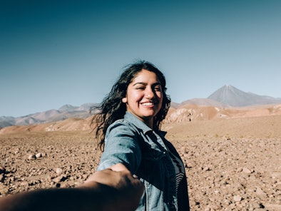 Young woman taking a selfie in the desert during the 2022 summer solstice, which will affect every z...