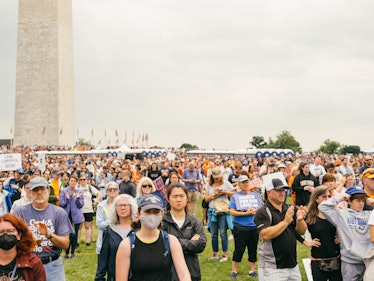 A photo showing the large crowd of attendees beneath the Washington Monument, listening to the speak...