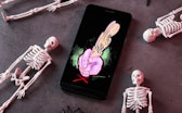 Skeleton figures surround a phone with the Miss type logo.