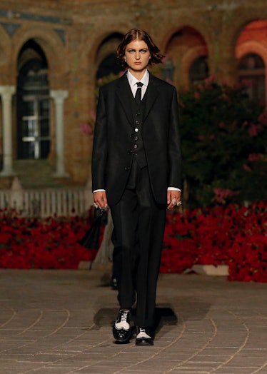 A female model walking in a Dior formal suit