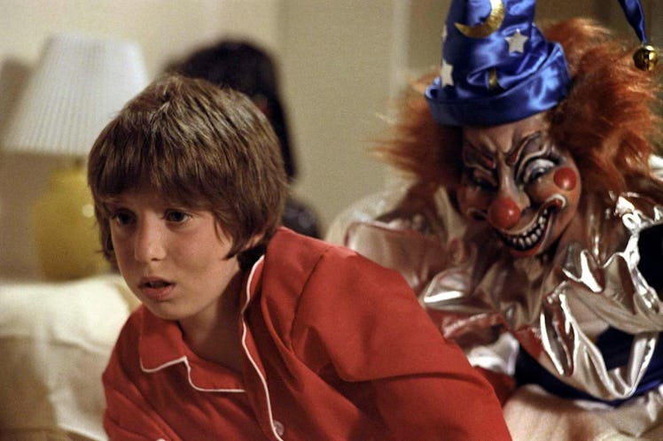 Clown sneaking behind Oliver Robin's back, who is starring as Robbie Freeling in the Poltergeist mov...