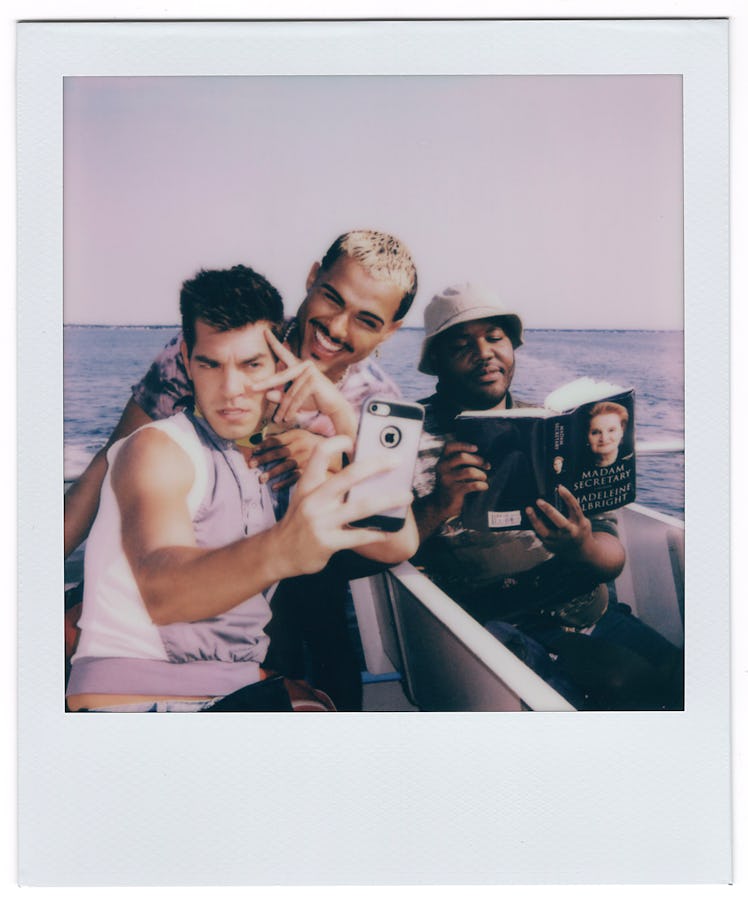 Matt Rogers, Tomás Matos, and Torian Miller on a boat