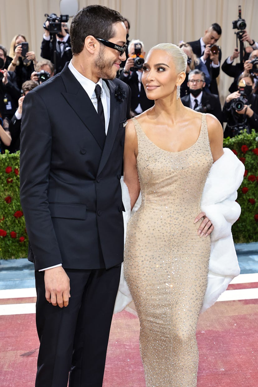 Kim Kardashian and Pete Davidson smiling at each other on the red carpet at the MET Gala 2022