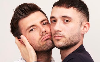 Eric Schwarau and Steven Phillips-Horst pressing their cheeks together.