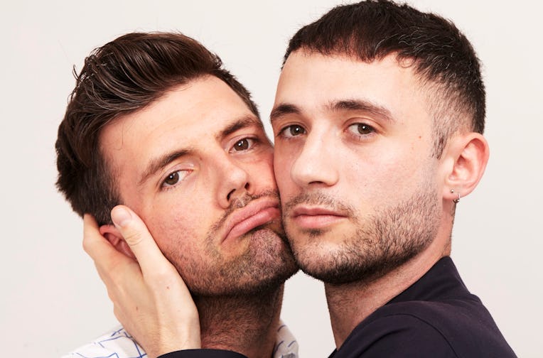 Eric Schwarau and Steven Phillips-Horst pressing their cheeks together.