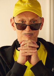 The writer and director John Waters wearing a yellow hat and black sunglasses from Calvin Klein's Pr...