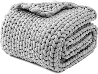 This chunky knit blanket features a modern chevron pattern.