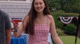 Belly Conklin wearing a red gingham dress on the 4th of July in 'The Summer I Turned Pretty'.