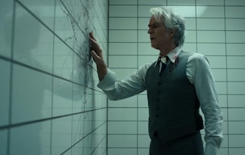 Dr. Martin Brenner (Matthew Modine) investigates a crack in a wall in Stranger Things 4 Vol. 2