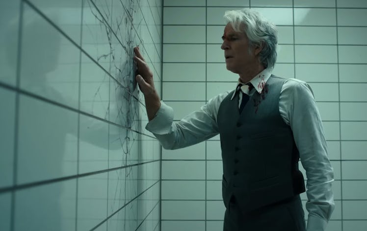 Dr. Martin Brenner (Matthew Modine) investigates a crack in a wall in Stranger Things 4 Vol. 2
