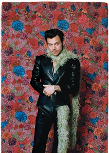 Gucci HA HA HA designer Harry Styles wearing a pale green feather boa and black leather jacket