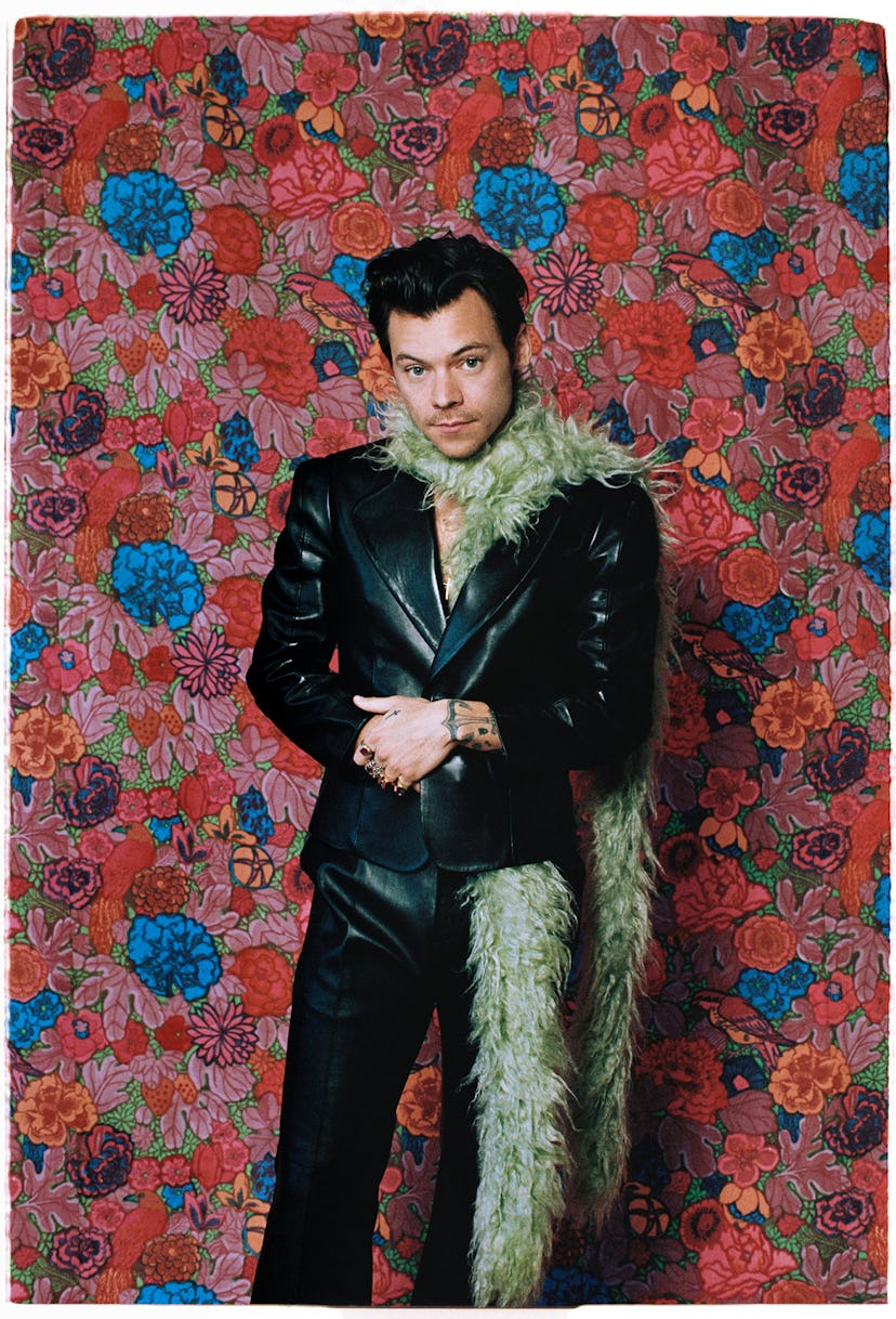 Gucci HA HA HA designer Harry Styles wearing a pale green feather boa and black leather jacket