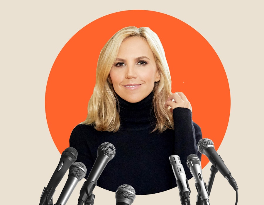 Tory Burch the fashion mogul in a black turtleneck sweater behind multiple microphones