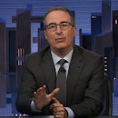 A still of John Oliver on set of 'Last Week Tonight' with a graphic reading "rent"