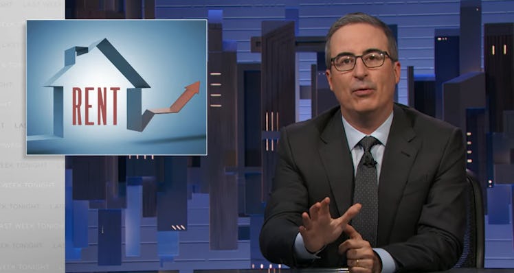 A still of John Oliver on set of 'Last Week Tonight' with a graphic reading "rent"
