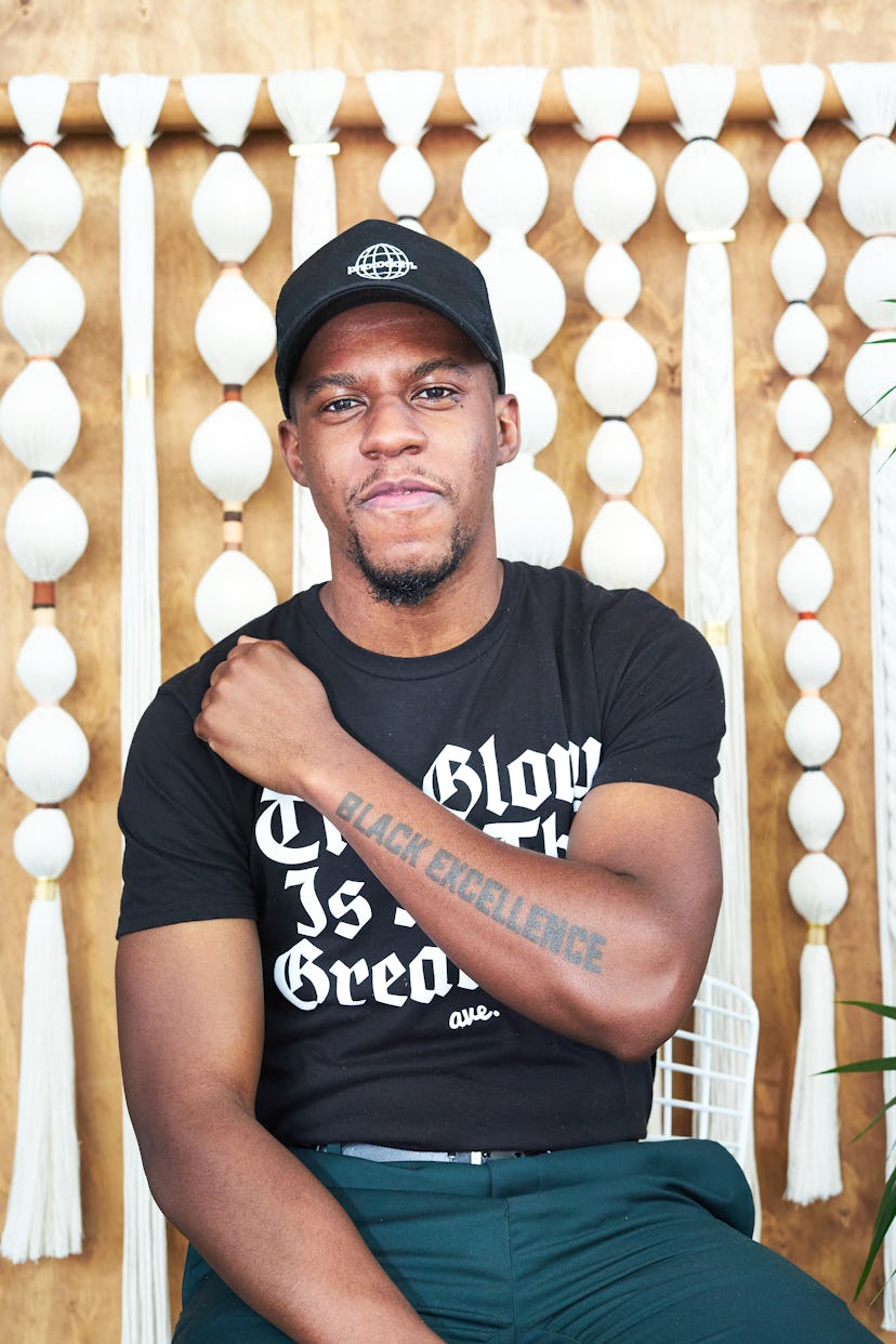 A person showing off a tattoo that reads "Black excellence"