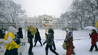 View of anti-abortion demonstrators, in a snowstorm outside the White House, during the annual March...